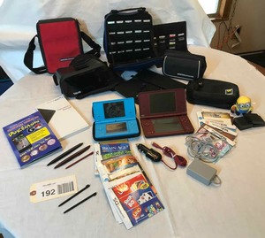 lot 192 image: Nintendo games & many SD cards, Pok�mon Go book, empty cases, Dream Vision by Tzumi