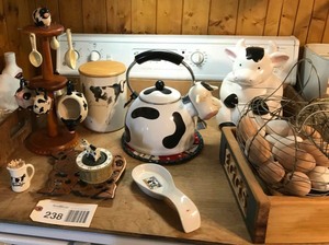 lot 238 image: Cows cookie jar, tea pot, measuring cups, trivet, ceramic eggs & egg basket, etc.