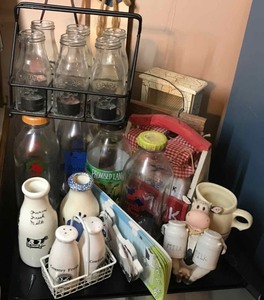 lot 286 image: Dairy theme bottles, candles, sign, salt and peppers, creamer