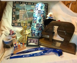 lot 315 image: Touch lamp, lanyards, coffee cups, plush eagle, 49 wood clock, patriotic wall signs