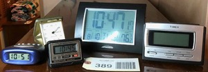 lot 389 image: Assorted small travel clocks, Atomix Clock with Day & Date