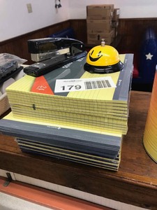 lot 179 image: Yellow Writing Tablets and Pads, Stapler, Bell