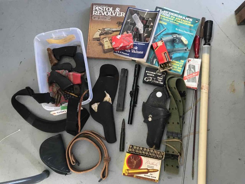 lot 590 image: Assorted  Grips, Misc. Ammo, Empty Ammo Boxes, Holsters, Books, Scope, Sling, Pouch, Etc.