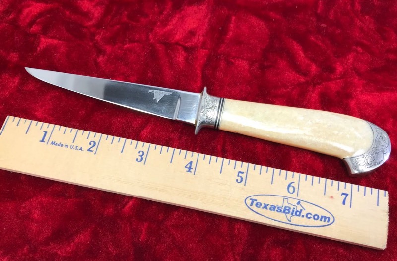 lot 111 image: Custom Knife  Maker Bates CA,  engraved #57, Mastadon handle,  approx. 7.75 in. overall