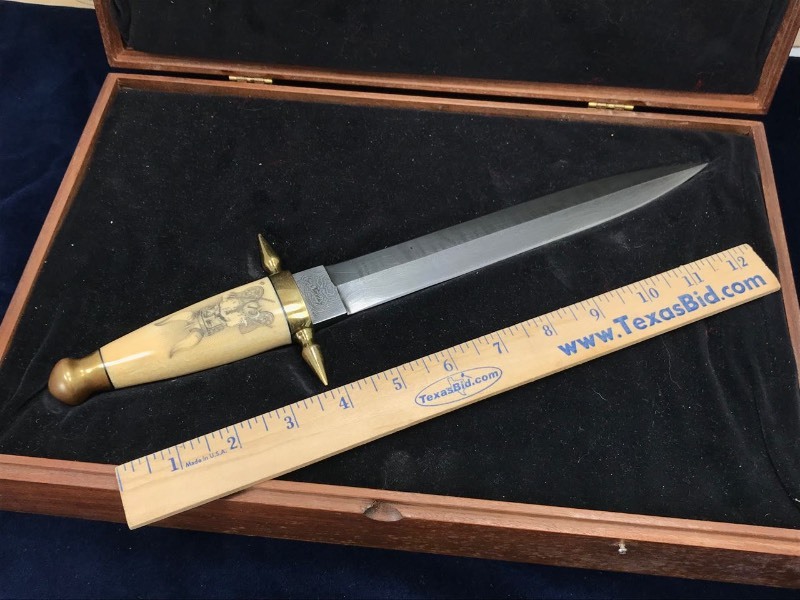 lot 149 image: Custom Knife  Kelly S. Kennedy J.S. Odessa TX AKA Noble House Armorers, Skrimshaw Viking, Damascus Dagger, Brass Fittings, Wood Case
