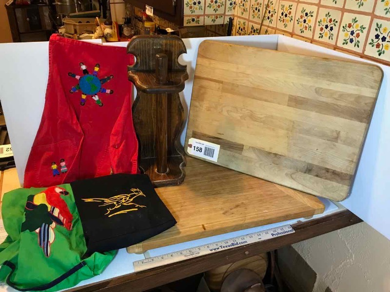 lot 158 image: (2) Cutting Boards  1 Footed, 1 Flat, Aprons, Paper Towel Holder