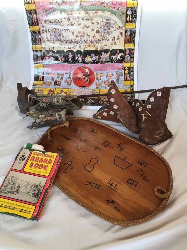 lot 584 image: Keystone Ranch, CO. Branding Iron, Boot Tops & Book the Centennial Brand Book, 1967.