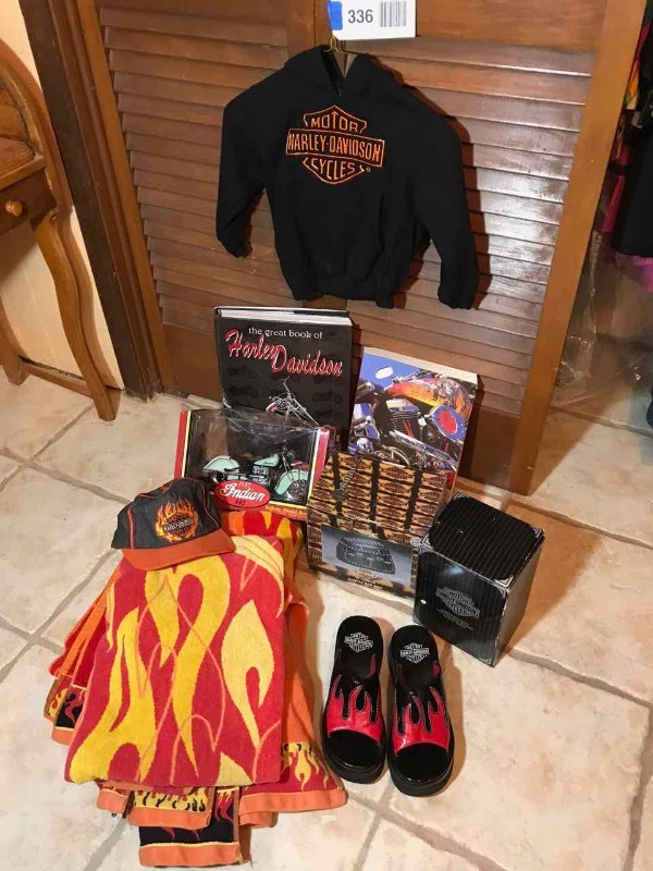 lot 336 image: Harley Davidson  Keychain, (2) Books, Childs Sweatshirt, Ball Cap, Ladies Sandals and (2) Flame Beach Towels