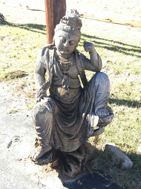 lot 915 image: Carved Wood Figure by Garage