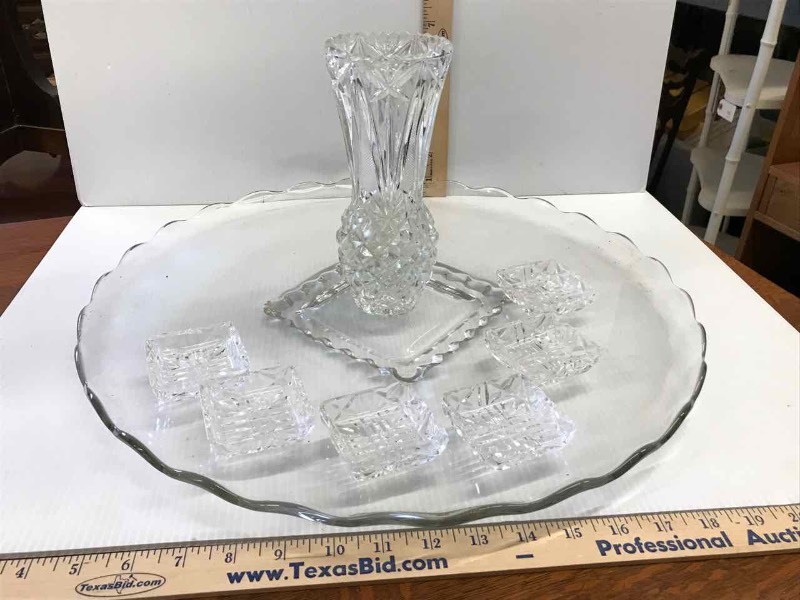 lot 81 image: Pressed Glass Torte Platter with Wavy Edges (18), Butter Pat DishesSalts, Vase