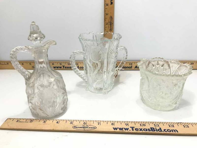 lot 132 image: Antique Thistle Pattern Pressed Glass Higbee Double Handled SpoonerCelery (bee in bottom), Vinegar Bottle and a Spooner (star)