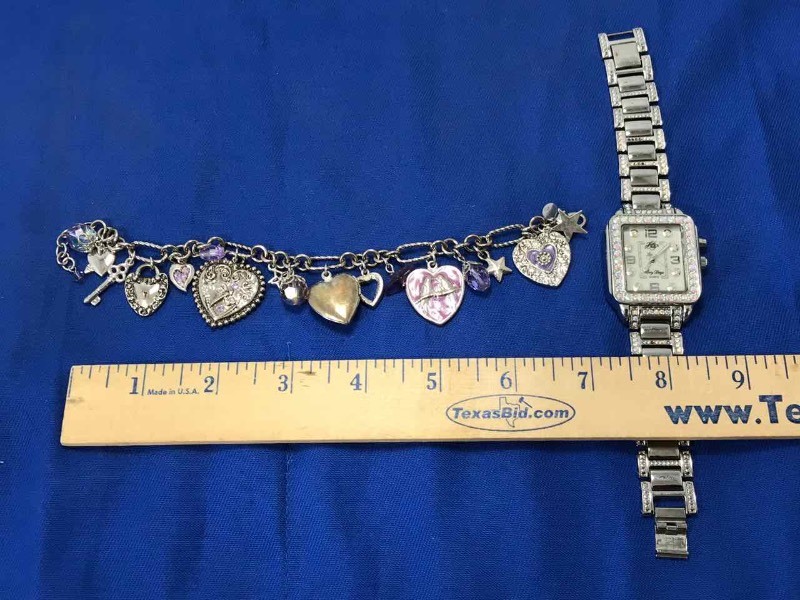 lot 128 image: Kirks Folly Charm Bracelet and Wrist Watch (Story Days)