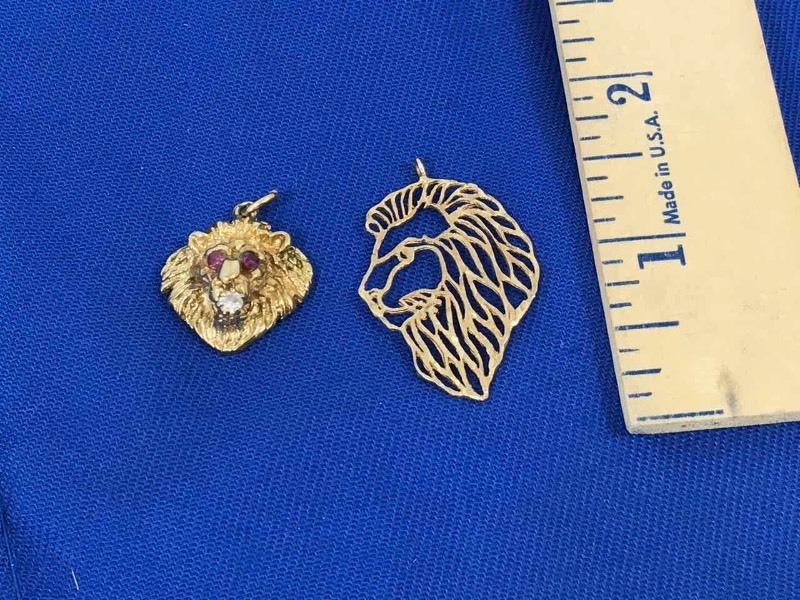 lot 152 image: (2) Pendants (Lions)  Cut Out 10K,  Red Stone Eyes