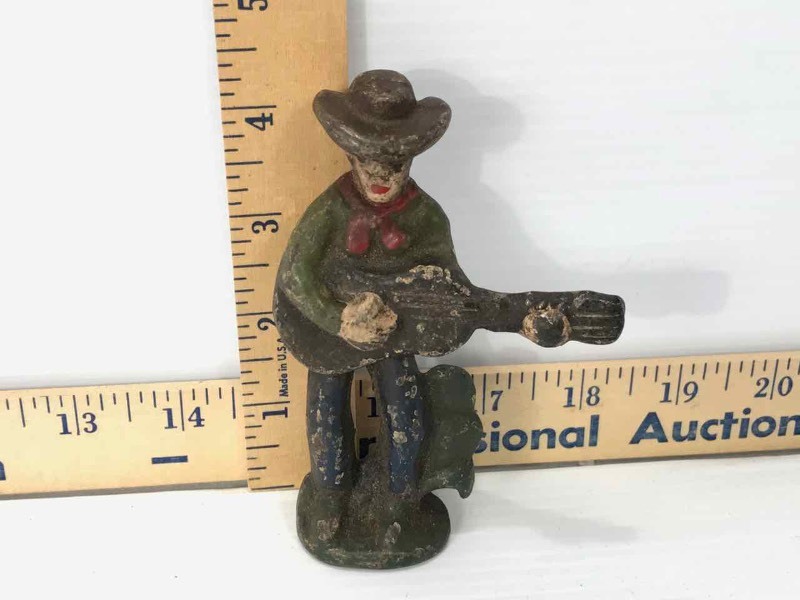 lot 646 image: Cast Iron  Bottle Opener (Guitar Playing Cowboy)