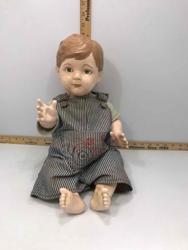 lot 183 image: Baby Boy Doll in Striped Coveralls