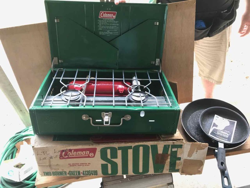 lot 374 image: Coleman Camp Stove (Coleman fuel type), folding stool, pans
