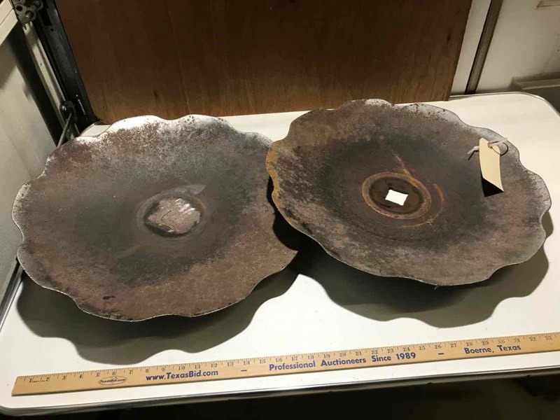 lot 24 image: Two plow discs, 22 inch diameter,  (one with hole welded up, one with hole)