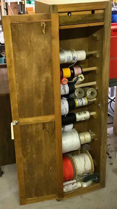 lot 265 image: Cabinet full of spools of twine & cord and assorted rope tooling
