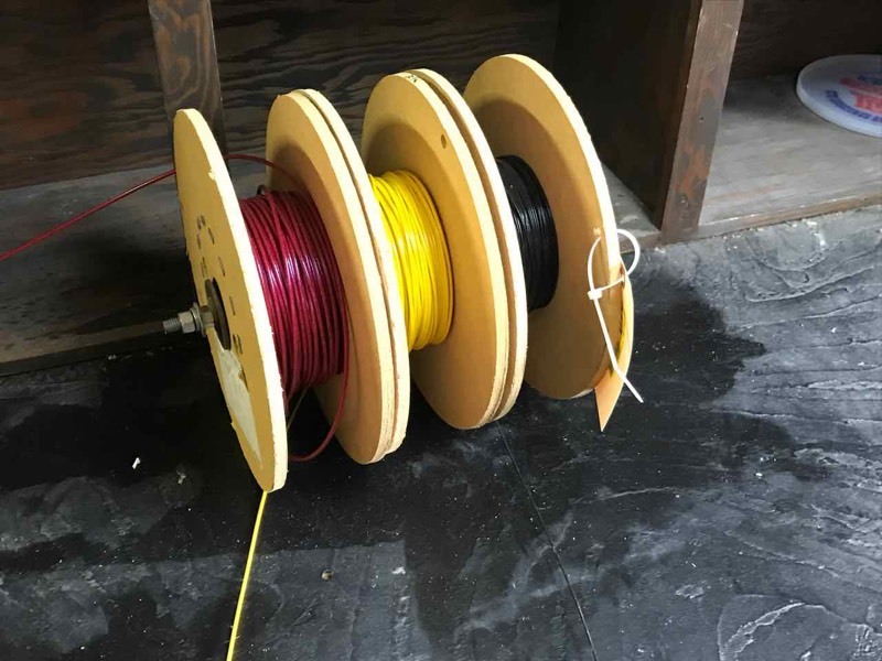 lot 310 image: Coated Cable  Three Spools, 18� in. to 116� in. (red, black, yellow), unknown lengths