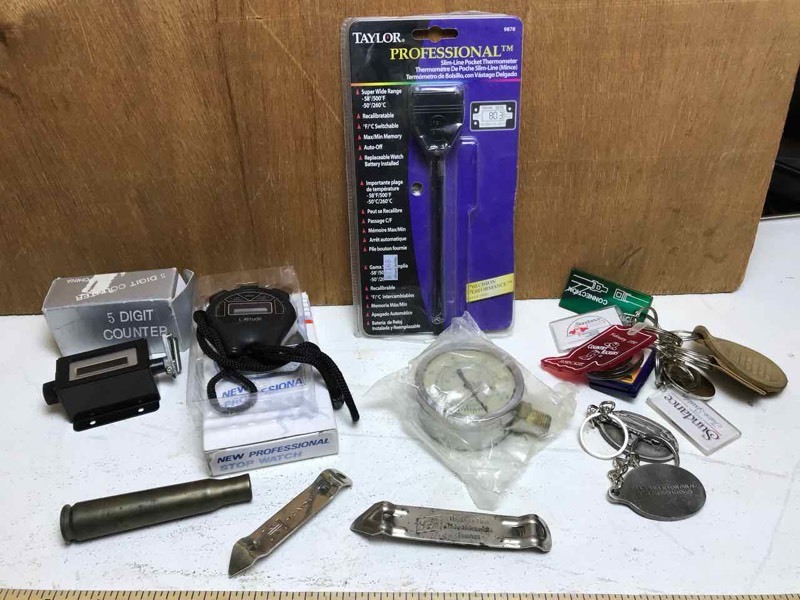 lot 358 image: Box with thermometer, digital counter, key chains, gauge, etc.