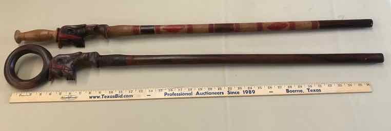 lot 240 image: (2) Canes Carved Face, Red Head Dress