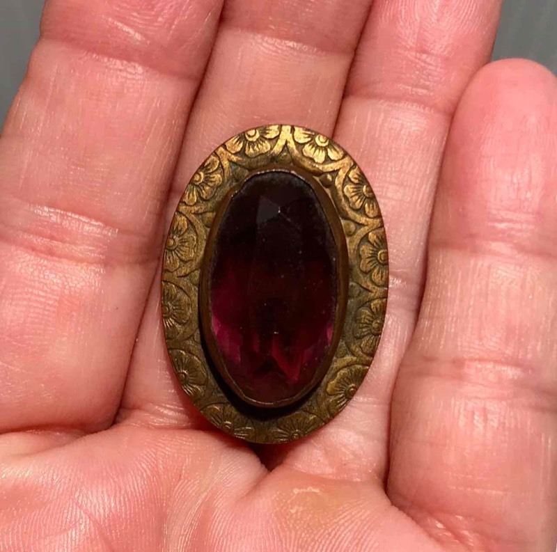 lot 304 image: Hat Pin Angled Oval Face with Purple Stone surrounded by Flower Motif