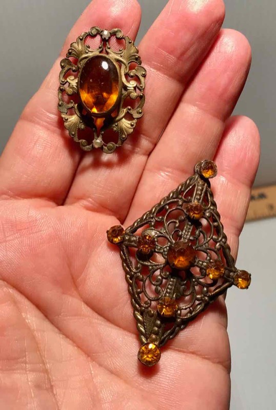 lot 393 image: (2) Hat Pins GoldAmber Colored Diamond Shaped Filigree Metal & Lacey Metal Oval with Oval Stone
