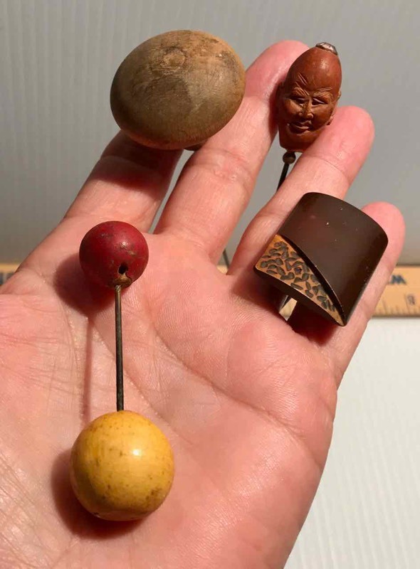 lot 424 image: (4) Hat Pins Wood (Carved Face, Balls, Knob, Rectangle)