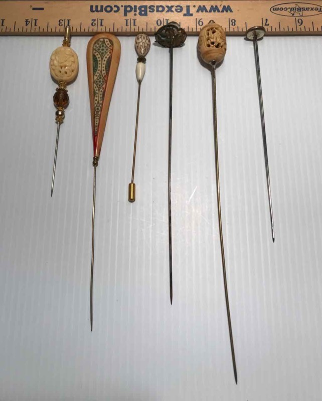 lot 428 image: (6) Hat Pins  ivory in color, carved designs, white bead