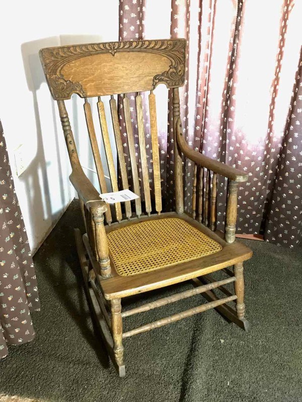 lot 5 image: Upstairs Antique Oak Pressed Back Arrow Rocker with Cane Seat, Turned Spindles