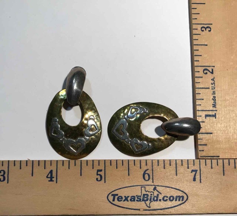 lot 919 image: Jewelry  Jeep Collins (1) pair of pierced earrings, oval hoop brass wsilver hearts