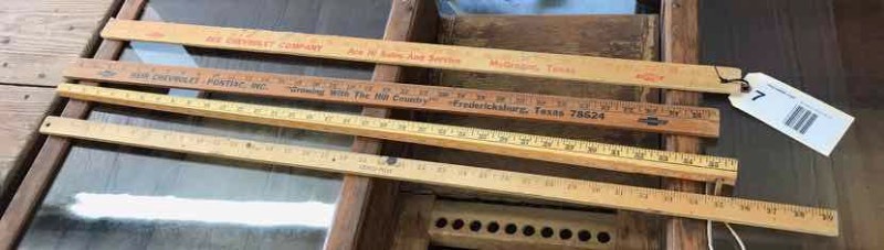 lot 7 image: (4) Yard Sticks Heir Chevrolet-Pontiac, Ace Chevrolet, Austin Trucking, Cenco