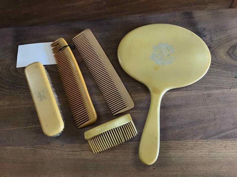 lot 229 image: Bakelite Hand Mirror, Combs, Brush, Hair Comb