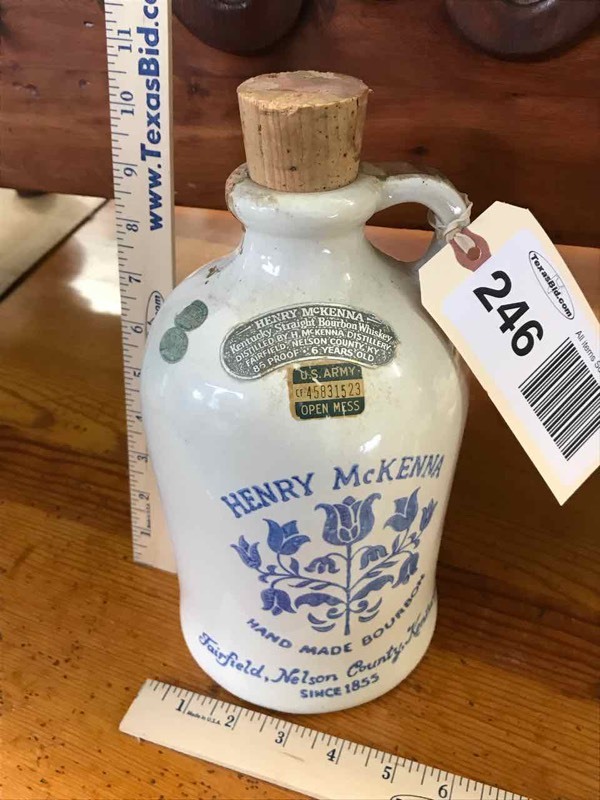 lot 246 image: Stoneware Jug Henry McKenna Kentucky Bourbon (notice the U.S. Army Open Mess Sticker)