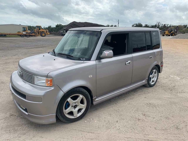 lot 415 image: Asset Forfeiture  2006 Toyota Scion, silver, standard transmission, started, see video, mileage 211,504  (VIN  JTLKT334X64089243)