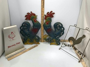 lot 908 image: (2) Kolie Cast Aluminum Wall Decor Roosters, (2) Book Stands