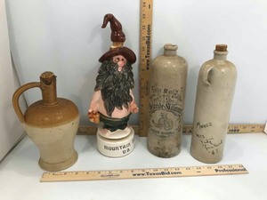 lot 981 image: (4) Bottles (3) Antique Stoneware Bottles (see writing) & (1) Musical Mountain Dew Decanter