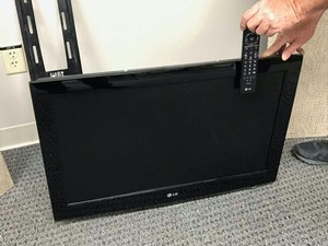 lot 63 image: LG Wall Mounted TV wremote, 32 in.  LCD, Mod. 32LCG30