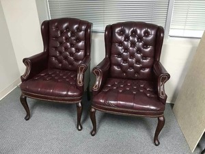 lot 100 image: (2) Tufted Wingback Chairs ( one has small cut in arm, see photo)