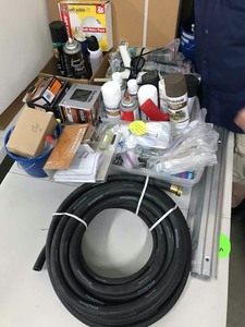 lot 472 image: Misc Fasteners, Hose (missing end) Drywall Toggles, DOT seals, 30A20A Brakers, Glue Gun, Metal Shelf Center