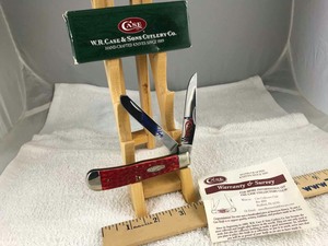 lot 748 image: Folding Knife W.R. Case 6254 Merry Christmas Red Trapper