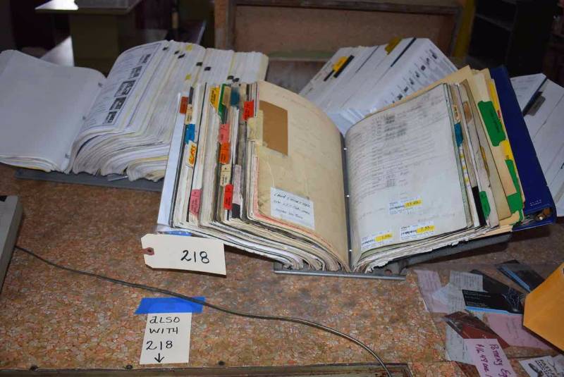 lot 218 image: (3) Metal CatalogBrochure Holders & Asst. Product CatalogsNotebooks