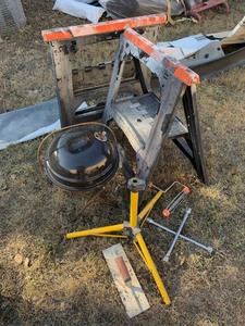 lot 12 image: Used Tools 4-Way Lug, Trowl, Small Grill, (2) Plastic Saw Horses