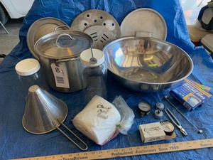 lot 60 image: (1) Large Stainless Steel Bowl, a small pot, asst. Pressure cooker parts, ricer, jars