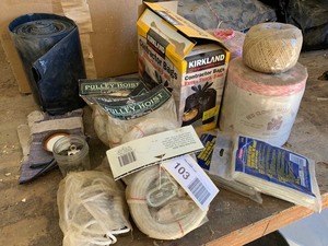 lot 103 image: (6) pulley hoists, (2) fiberglass cloth, Contractor bags, Baler twine, etc.